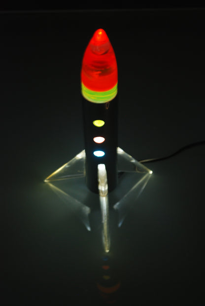 Raket lamp staand op 3 vleugels met gekleurde schijven punt. *