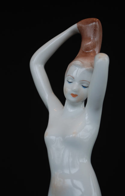 Naakt Vrouw staand met handen in het haar haren. Beeld