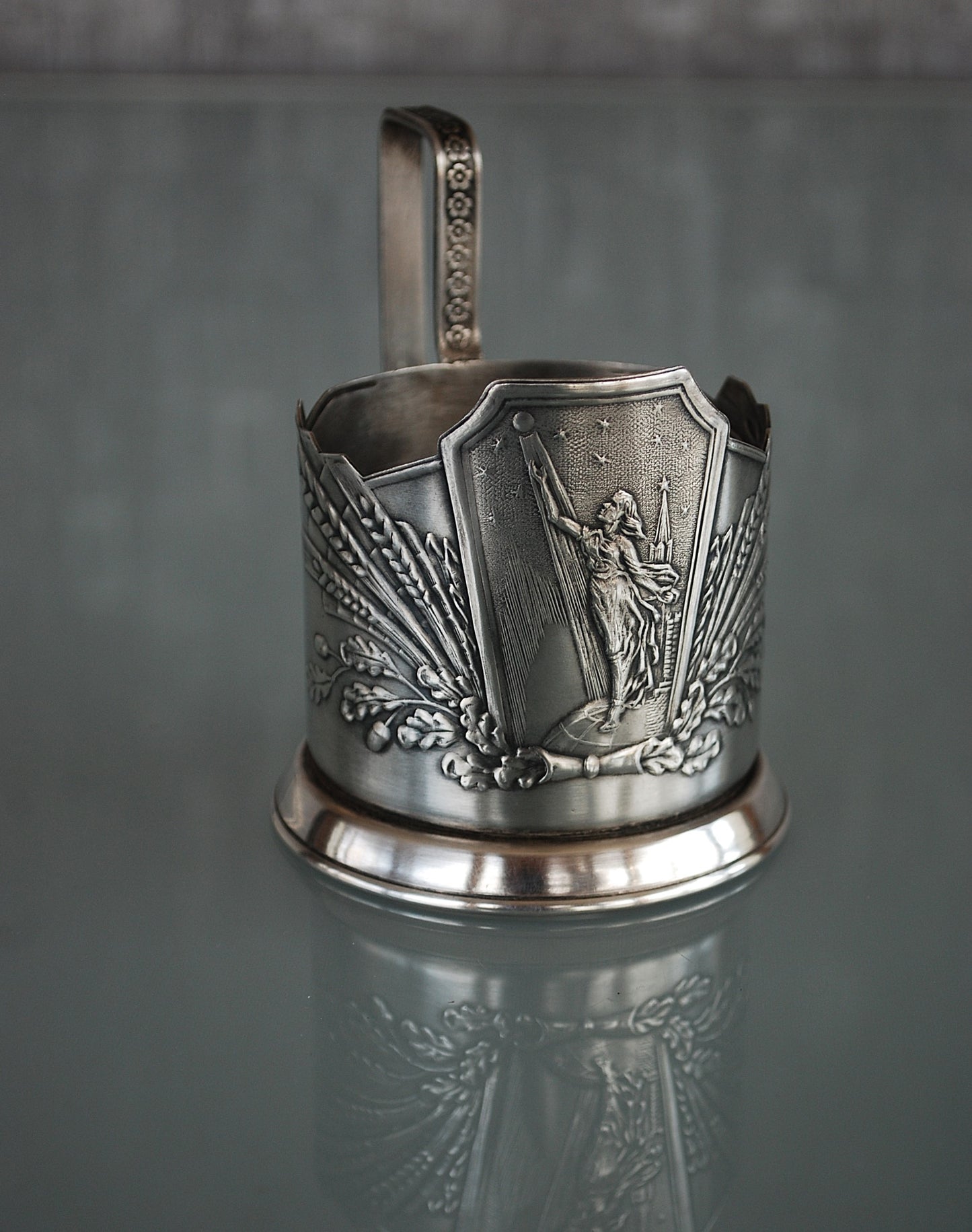 Sovjet theeglas houder met glas. Vrouw met Spoetnik in haar hand, reikt naar de sterren