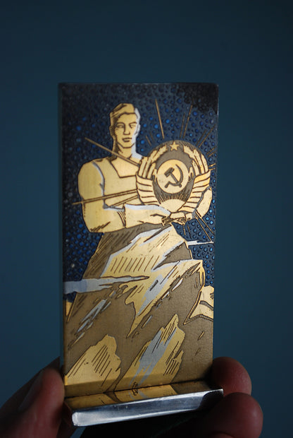 CCCP coat of arms in the hands of a worker *
